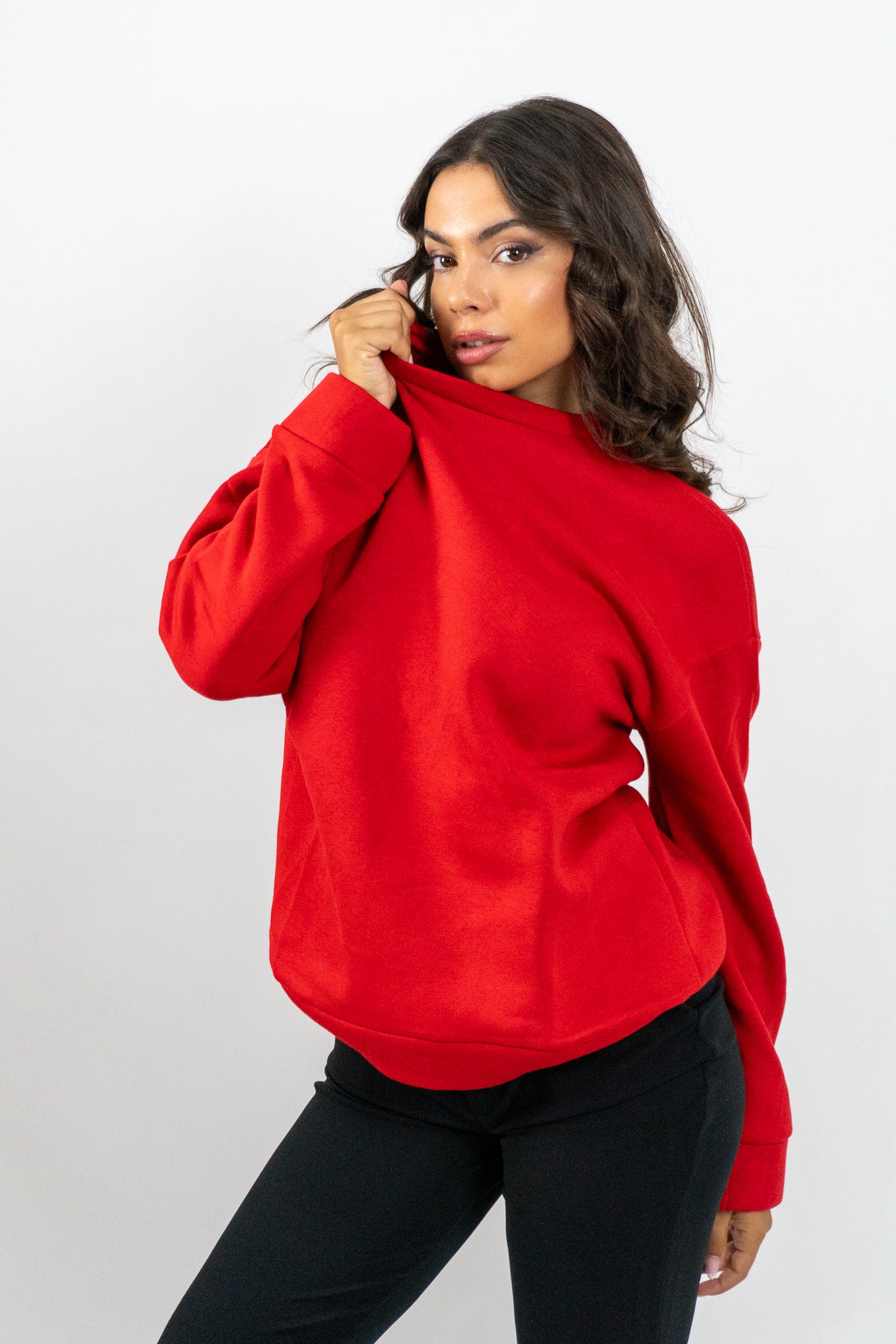 Woman wearing a red hoodie on a white background