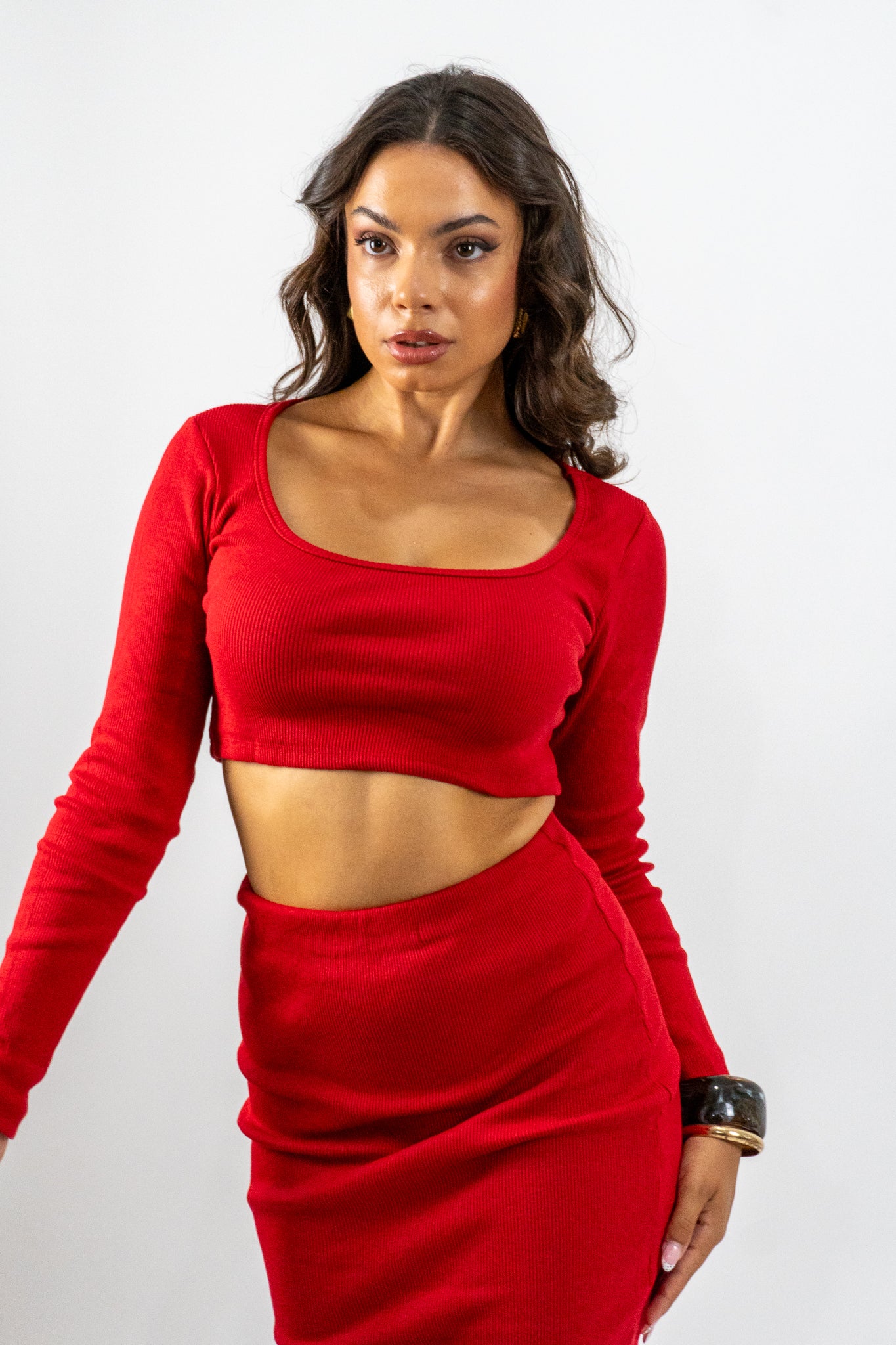 Woman wearing a red outfit against a white background